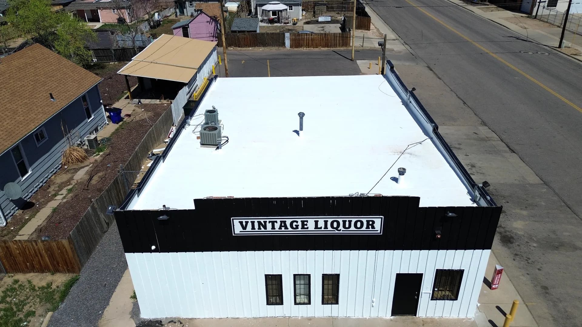 Aerial view of the completed bright white Johns Manville TPO membrane roof on the Vintage Liquor building in Greeley, Colorado