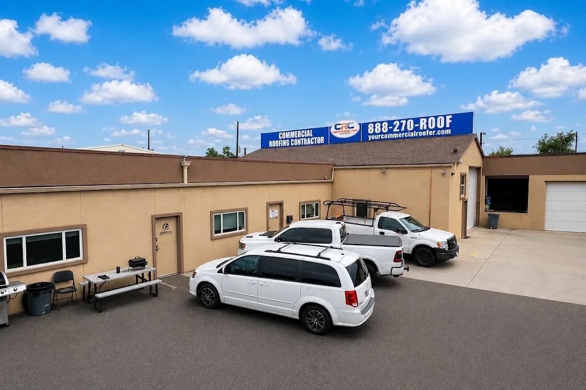 The Commercial Roofing Contractor Denver office building, with the company sign above the roofline and work trucks parked outside