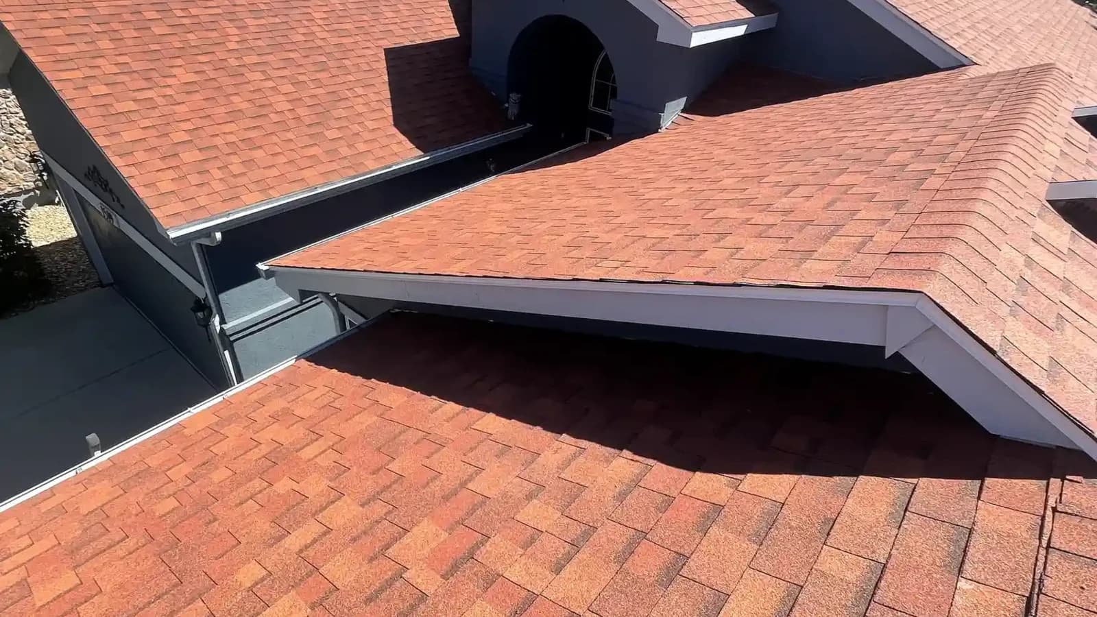 Aerial view of a completed shingle roof with dormers on a residential home in Aurora, Colorado, after a hail insurance reroof