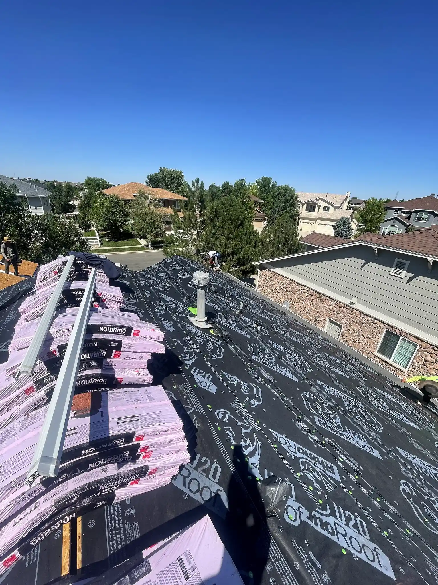 Synthetic underlayment installed on a residential roof deck before shingle installation in Aurora, Colorado