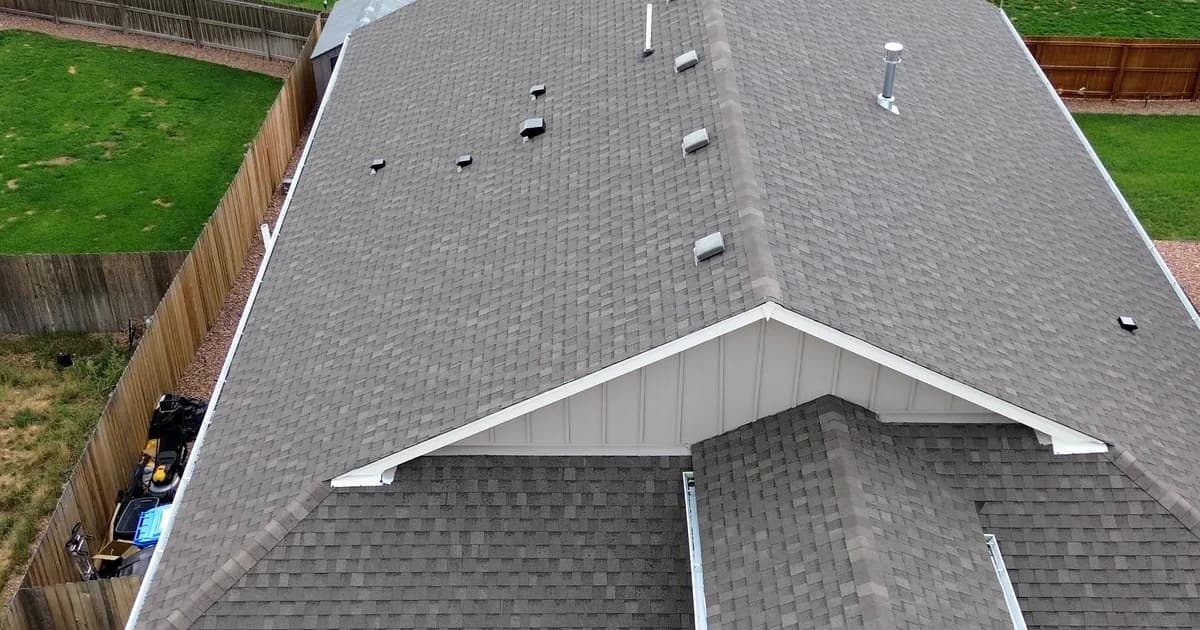 Aerial drone view of a completed new asphalt shingle roof on a Colorado home